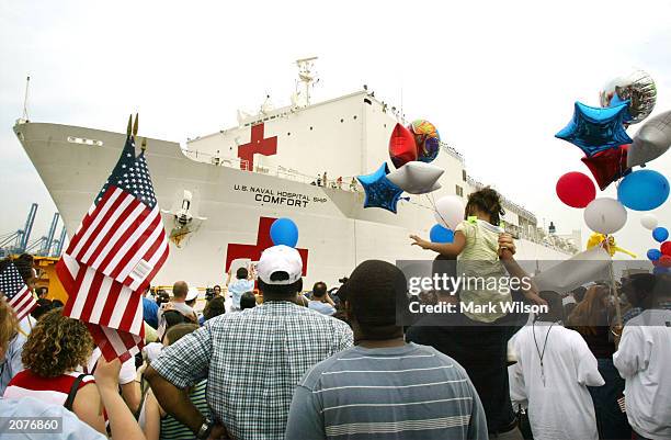 Crowd greets the hospital ship USS Comfort as it pulls up to the dock June 12, 2003 in Baltimore, Maryland. The USS Comfort spent 56 consecutive days...