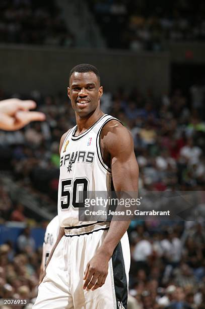 David Robinson of the San Antonio Spurs smiles in Game one of the 2003 NBA Finals against the New Jersey Nets at SBC Center on June 4, 2003 in San...
