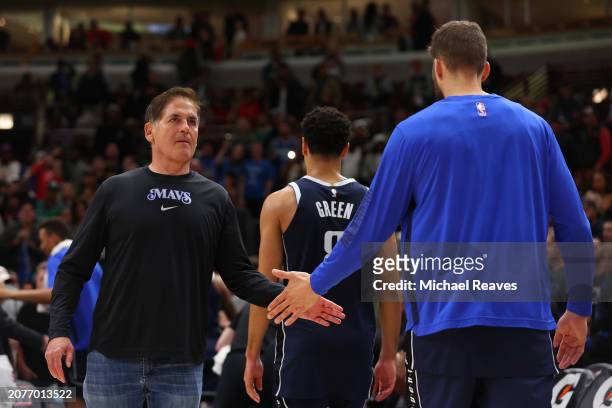 Mark Cuban of the Dallas Mavericks high fives Maxi Kleber after they defeated the Chicago Bulls at the United Center on March 11, 2024 in Chicago,...
