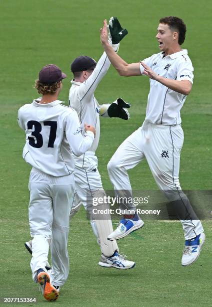 Mitchell Perry of Victoria celebrates getting the wicket of Aaron Hardie of Western Australia during the Sheffield Shield match between Victoria and...