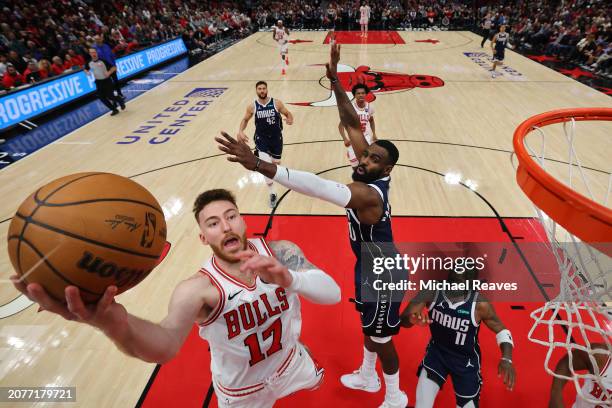 Onuralp Bitim of the Chicago Bulls goes up for a layup against Tim Hardaway Jr. #10 of the Dallas Mavericks at the United Center on March 11, 2024 in...