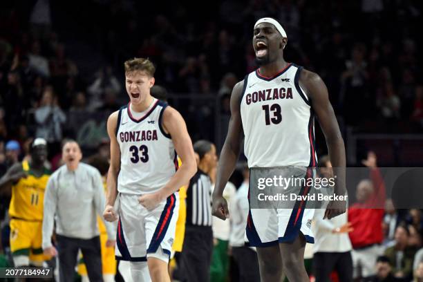 Ben Gregg and Graham Ike of the Gonzaga Bulldogs react after a three-pointer against the San Francisco Dons in the first half of a semifinal game of...