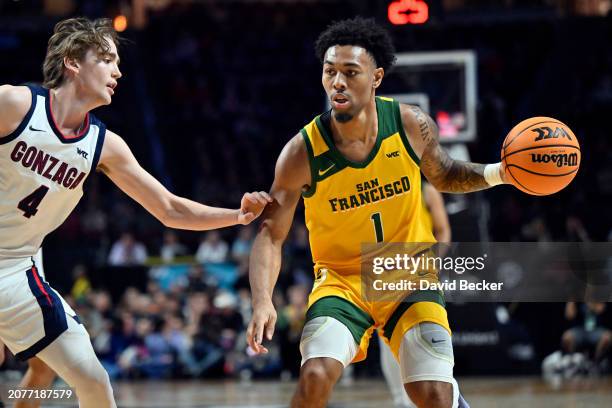 Malik Thomas of the San Francisco Dons controls the ball against Dusty Stromer of the Gonzaga Bulldogs in the first half of a semifinal game of the...