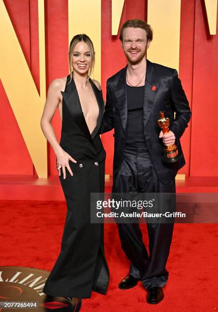 Claudia Sulewski and Finneas O'Connell attend the 2024 Vanity Fair Oscar Party hosted by Radhika Jones at Wallis Annenberg Center for the Performing...