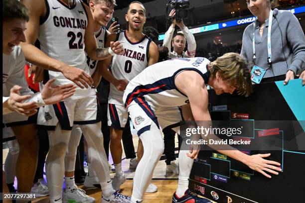 Dusty Stromer of the Gonzaga Bulldogs slaps on the bracket sticker after the Bulldogs defeated the Gonzaga Bulldogs in a semifinal game of the West...