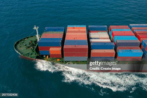 aerial view container cargo ship full speed with beautiful wave pattern carrier container on the sea for business logistics, import export, shipping or freight transportation. - full elevator stock pictures, royalty-free photos & images