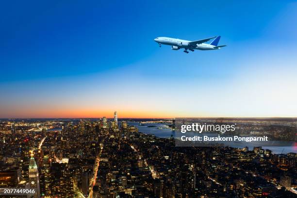 view from airplane window. flying over new york city. - sunrise over water stock pictures, royalty-free photos & images
