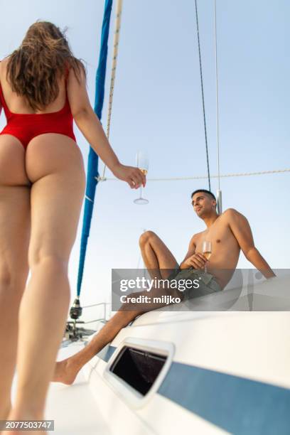 young couple relaxing on sailing - young couple sailing stock pictures, royalty-free photos & images