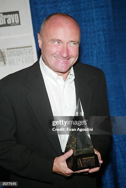 Inductee musician Phil Collins poses in the press room at the Annual Songwriters Hall of Fame Awards ceremony and dinner at the Marriott Marquis June...