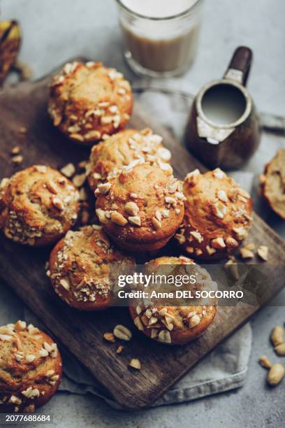 homemade banana muffins with peanuts milk glass on a grey background - muffin stock pictures, royalty-free photos & images