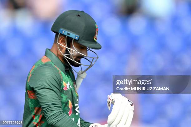 Bangladesh's Litton Das walks off the field after being dismissed by Sri Lanka's Dilshan Madushanka during the second one-day international cricket...