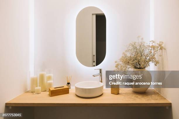 washbasin with modern decoration in natural tones, with paniculata flowers and candles - lavabo photos et images de collection