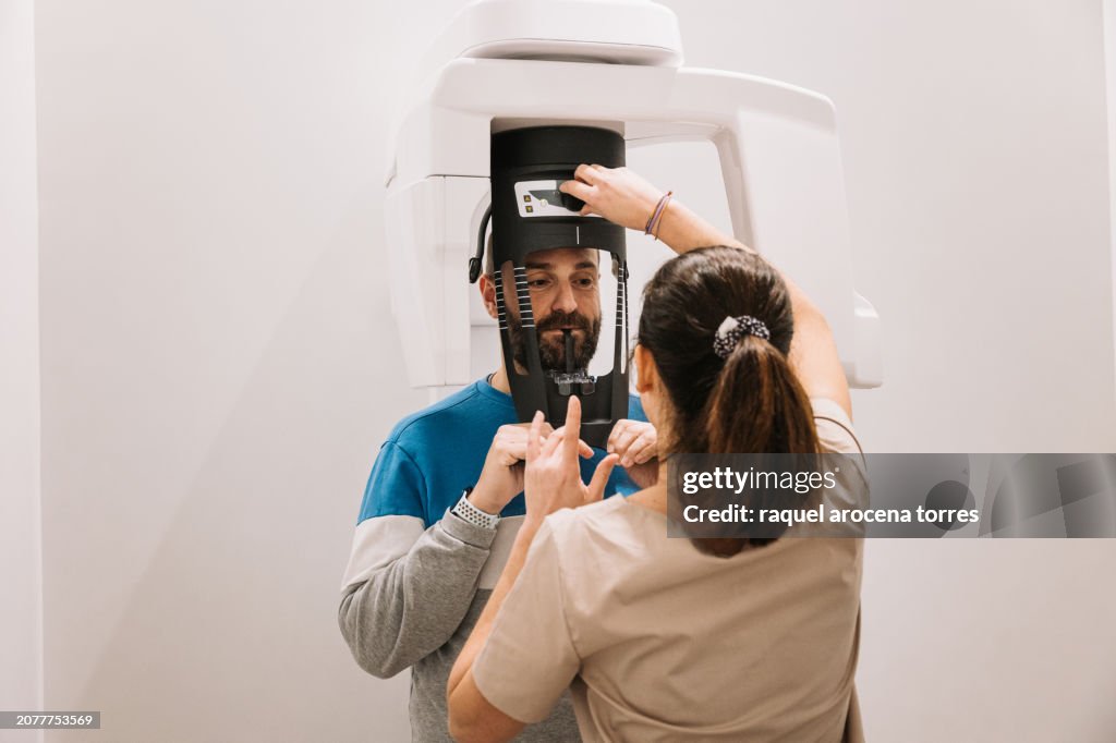 Dentist performing a dental x-ray on a patient