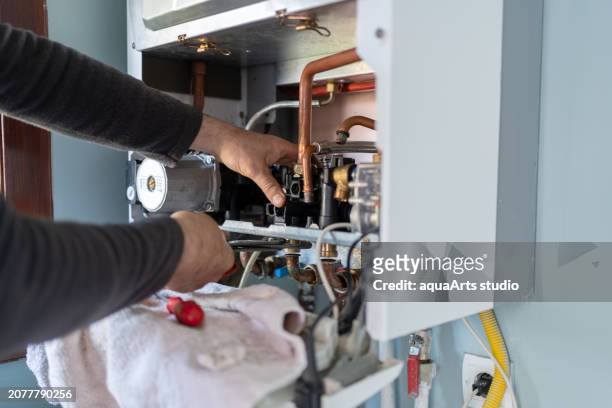 gas heating boiler service at home - broken boiler foto e immagini stock