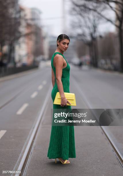 Sarah Posch seen wearing Karl Lagerfeld green long knit dress, Karl Lagerfeld yellow leather clutch bag and Liu Jo yellow leather heels, on March 09,...