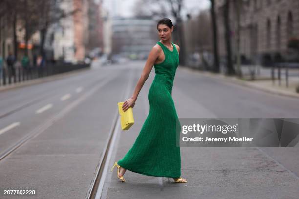 Sarah Posch seen wearing Karl Lagerfeld green long knit dress, Karl Lagerfeld yellow leather clutch bag and Liu Jo yellow leather heels, on March 09,...