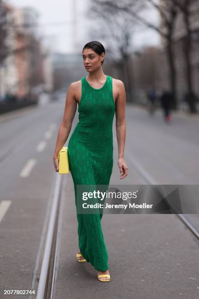 Sarah Posch seen wearing Karl Lagerfeld green long knit dress, Karl Lagerfeld yellow leather clutch bag and Liu Jo yellow leather heels, on March 09,...