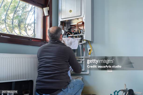 gas heating boiler service at home - gas boiler stock pictures, royalty-free photos & images