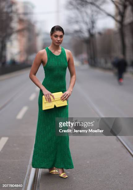 Sarah Posch seen wearing Karl Lagerfeld green long knit dress, Karl Lagerfeld yellow leather clutch bag and Liu Jo yellow leather heels, on March 09,...