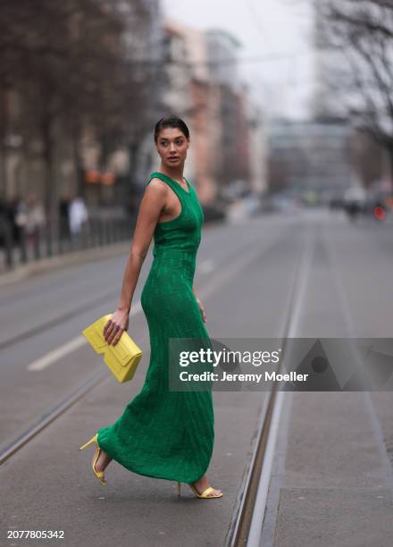 Sarah Posch seen wearing Karl Lagerfeld green long knit dress, Karl Lagerfeld yellow leather clutch bag and Liu Jo yellow leather heels, on March 09,...