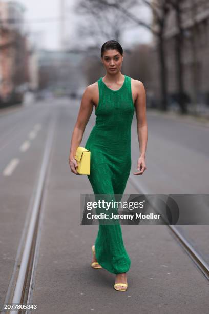 Sarah Posch seen wearing Karl Lagerfeld green long knit dress, Karl Lagerfeld yellow leather clutch bag and Liu Jo yellow leather heels, on March 09,...