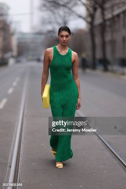 Sarah Posch seen wearing Karl Lagerfeld green long knit dress, Karl Lagerfeld yellow leather clutch bag and Liu Jo yellow leather heels, on March 09,...