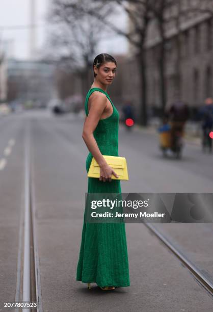 Sarah Posch seen wearing Karl Lagerfeld green long knit dress, Karl Lagerfeld yellow leather clutch bag and Liu Jo yellow leather heels, on March 09,...