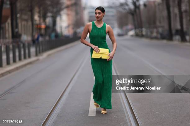 Sarah Posch seen wearing Karl Lagerfeld green long knit dress, Karl Lagerfeld yellow leather clutch bag and Liu Jo yellow leather heels, on March 09,...