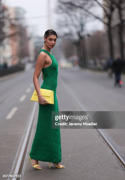 Sarah Posch seen wearing Karl Lagerfeld green long knit dress, Karl Lagerfeld yellow leather clutch bag and Liu Jo yellow leather heels, on March 09,...