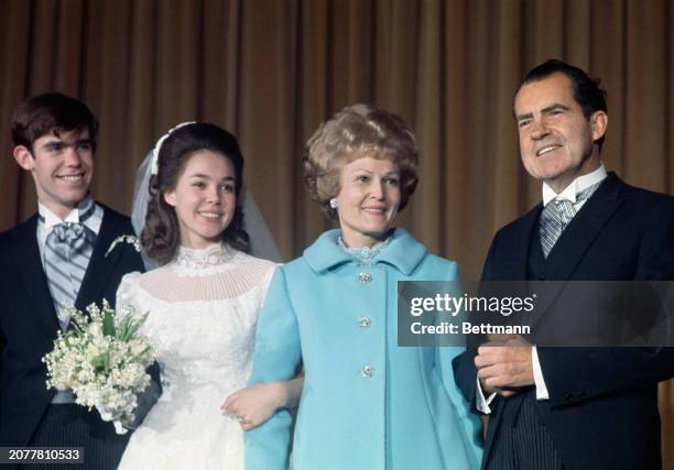 Newly-weds David and Julie Eisenhower posing with the bride's parents, President-elect Richard Nixon and his wife Pat at a reception following their...