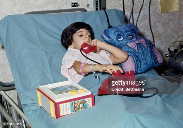 Maria Giannaris, aged five, speaking on the phone from her bed at Texas Children's Hospital in Houston, Texas, August 19th 1968. Maria, from...