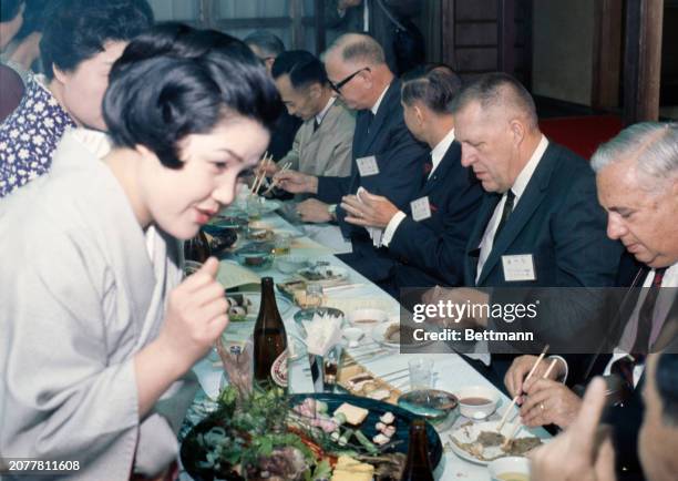 Governors attempting to eat with chopsticks during a barbecue luncheon in Yoro Park, Gifu, Japan, April 18th 1968. The Governors were in Japan to...