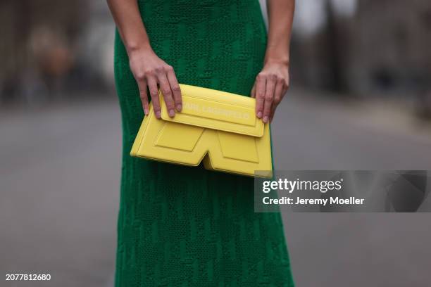 Sarah Posch seen wearing Karl Lagerfeld green long knit dress and Karl Lagerfeld yellow leather clutch bag, on March 09, 2024 in Berlin, Germany.