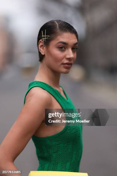 Sarah Posch seen wearing Karl Lagerfeld green long knit dress and Karl Lagerfeld yellow leather clutch bag, on March 09, 2024 in Berlin, Germany.