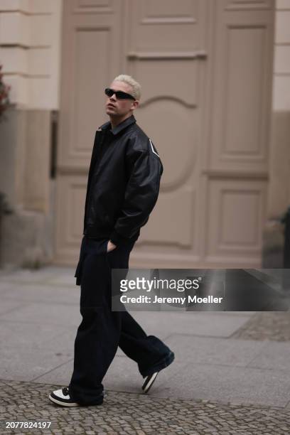 Federico Spinas seen wearing black sunglasses, black cotton basic t-shirt, Review black oversized leather bomber jacket, dark blue baggy denim /...