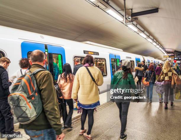 Passengers waiting to board subway train in Stockholm