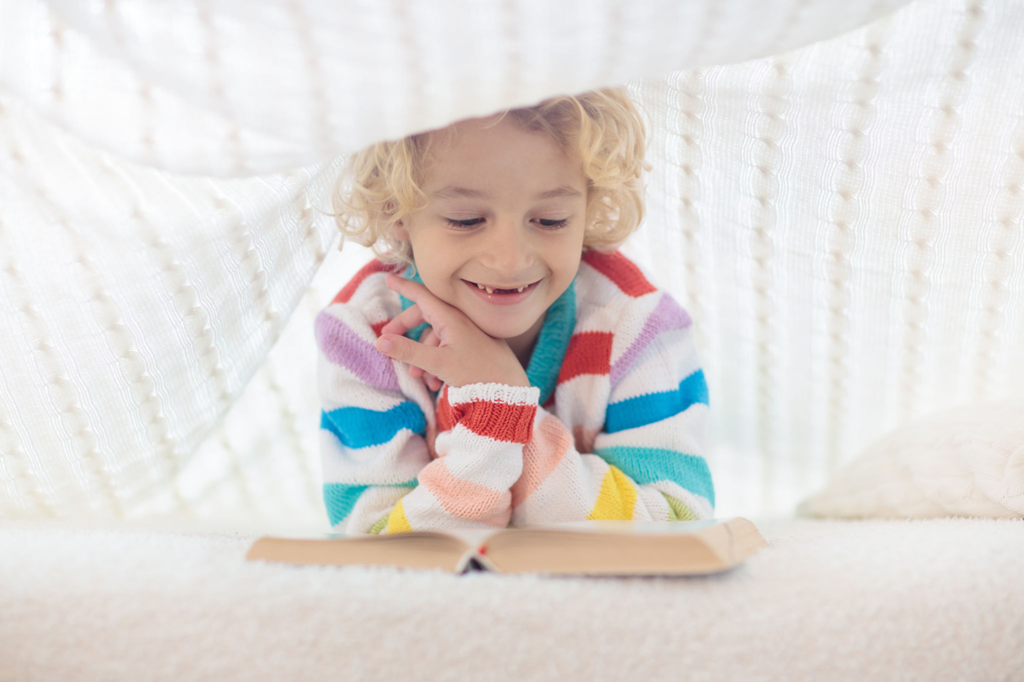 Child reading book in bed. Kids read books. Child reading book in bed. Kids read books.