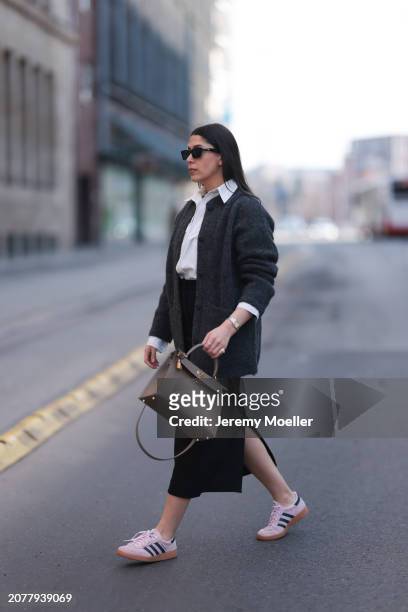 Tugba Kement seen wearing black sunglasses, Sézane dark grey wool knit long cardigan, white cotton buttoned shirt, COS black midi long skirt, Hermès...