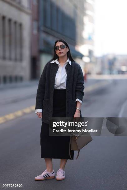 Tugba Kement seen wearing black sunglasses, Sézane dark grey wool knit long cardigan, white cotton buttoned shirt, COS black midi long skirt, Hermès...