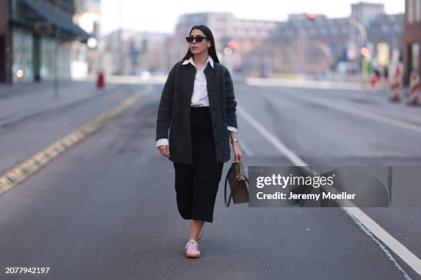 Tugba Kement seen wearing black sunglasses, Sézane dark grey wool knit long cardigan, white cotton buttoned shirt, COS black midi long skirt, Hermès...