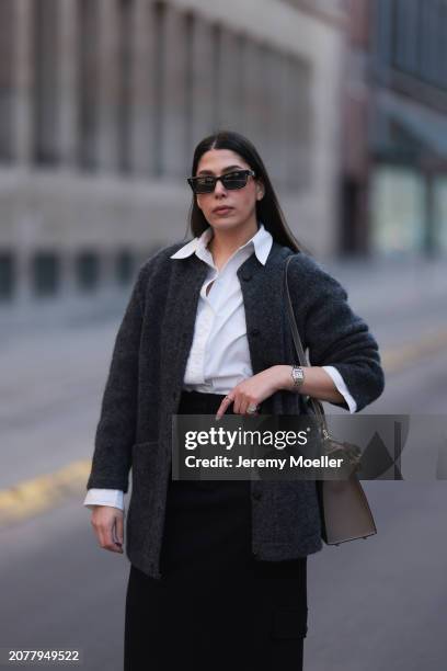 Tugba Kement seen wearing black sunglasses, Sézane dark grey wool knit long cardigan, white cotton buttoned shirt, COS black midi long skirt, Hermès...