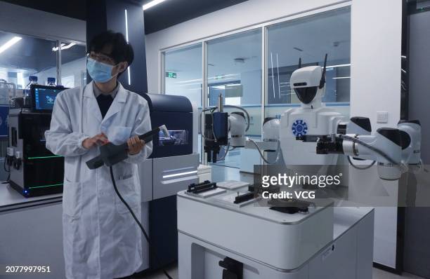 Scientific researcher operates a microfluidic liquid handling robot of Single-cell Proteome Analysis Platform at a laboratory of Zhejiang...