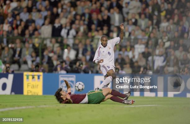 Portuguese footballer Fernando Couto on the ground as French footballer Nicolas Anelka plays the ball during the UEFA Euro 2000 semifinal between...