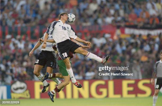 German footballer Michael Ballack, Portugal footballer Capucho, and German footballer Sebastian Deisler jump for the ball during the UEFA Euro 2000...