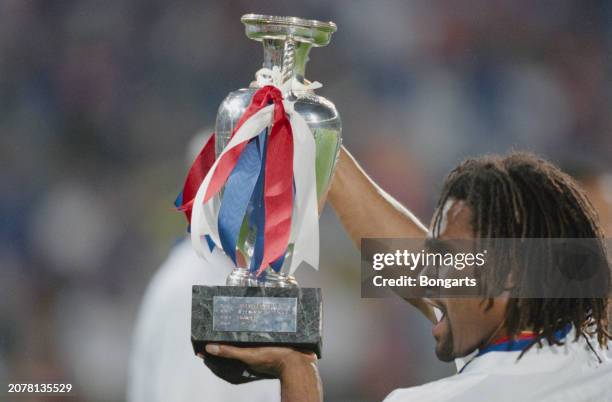 France footballer Christian Karembeu celebrates with the trophy after the UEFA Euro 2000 final between France and Italy, at Stadion Feijenoord in...