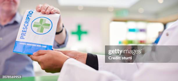 female pharmacist handing prescription - pharmacy stock pictures, royalty-free photos & images