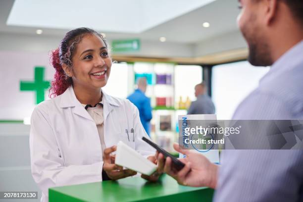 pharmacy payment by phone - pharmacist phone stock pictures, royalty-free photos & images