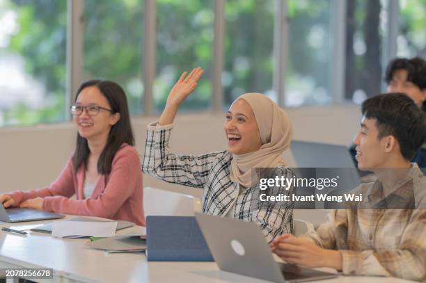 asian female student rise hand - asian-students-classroom-computer stock pictures, royalty-free photos & images