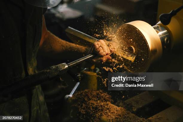 Artisan Julie Jackson is photographed using a woodturner for a vase in her studio for Los Angeles Times on April 5, 2023 in Los Angeles, California....
