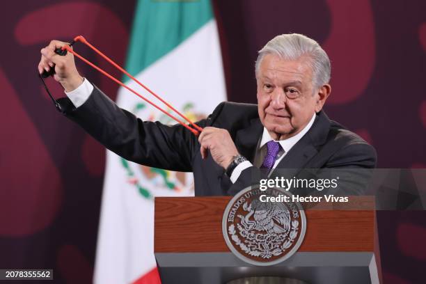 President of Mexico Andres Manuel Lopez Obrador shows a slingshot, stones and pellets allegedly used by the students of Ayotzinapa in the protest...